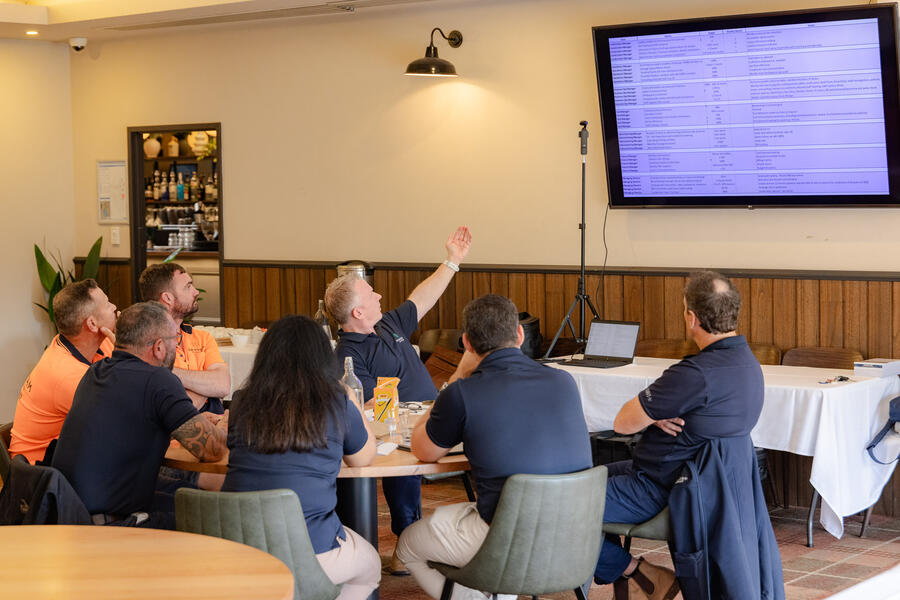 Brad leading a workshop with a team reviewing plans on screen